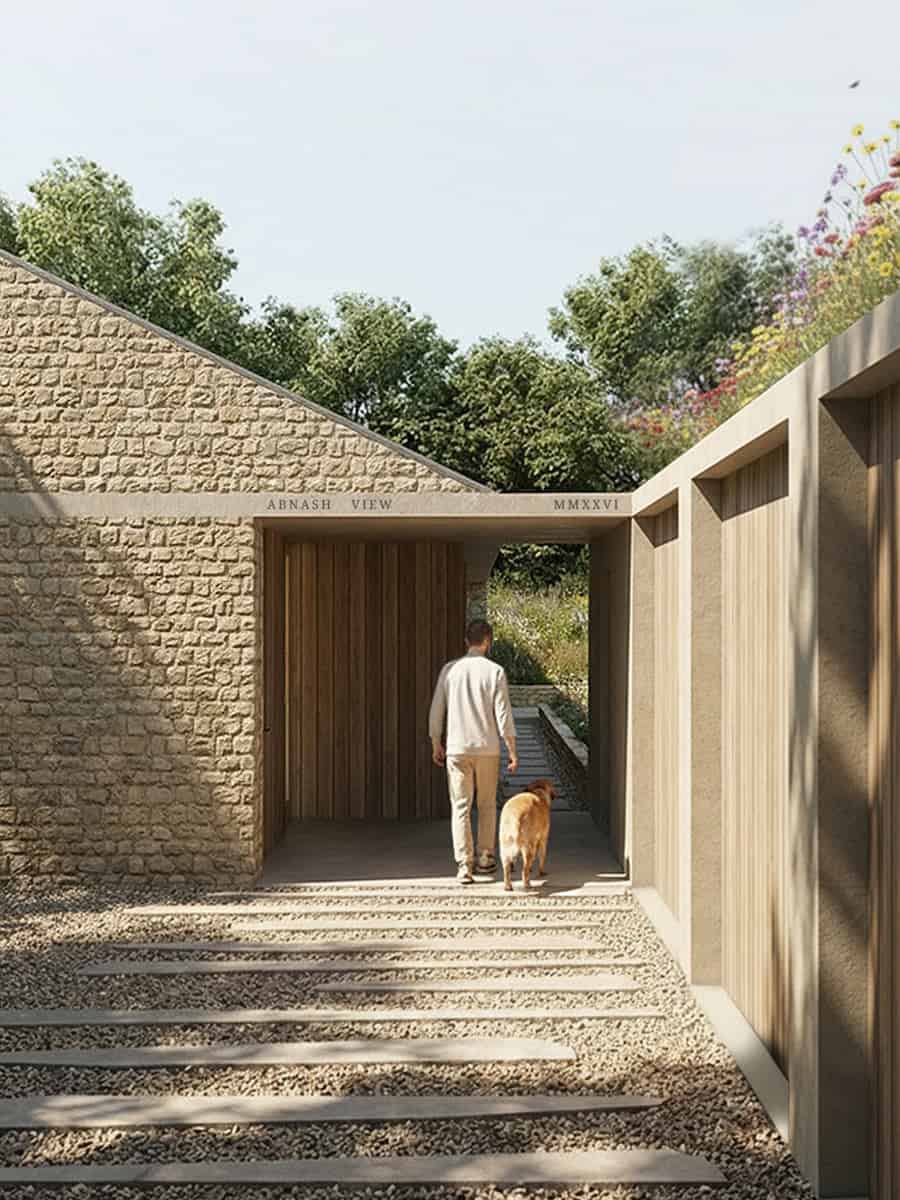 Abnash View entrance: a Cotswold stone gable and timber-lined passage beneath a wildflower roof