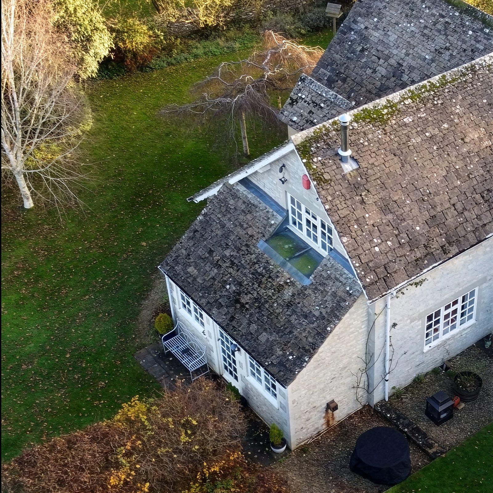The cottage from above before work began, showing the old stone-tiled roofs and rear garden